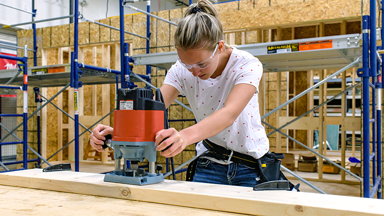Female-construction-trades-pre-apprenticeship-student-works-on-a-project-in-the-shop-space