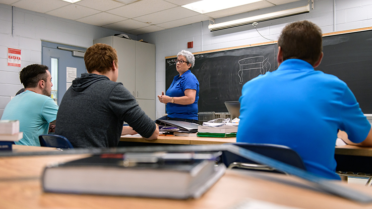 Georgian-College-carpentry-instructor-and-coordinator-Lynn-MacKinlay-teaches-students-at-the-front-of-the-class